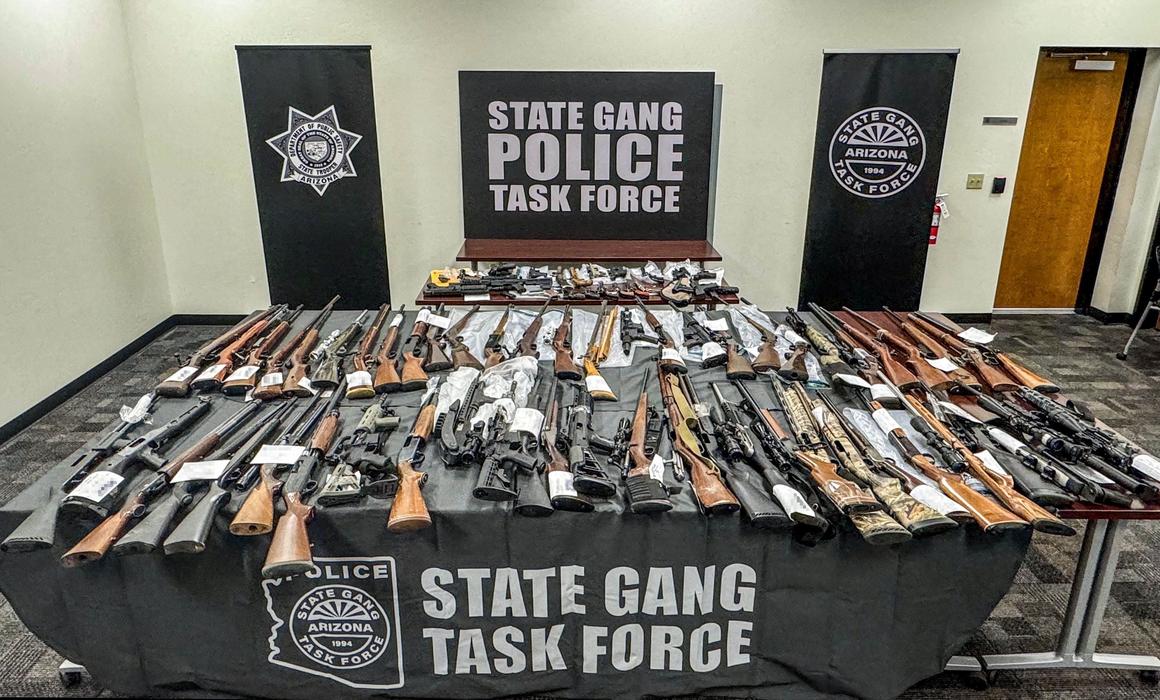 Seized firearms displayed on a table