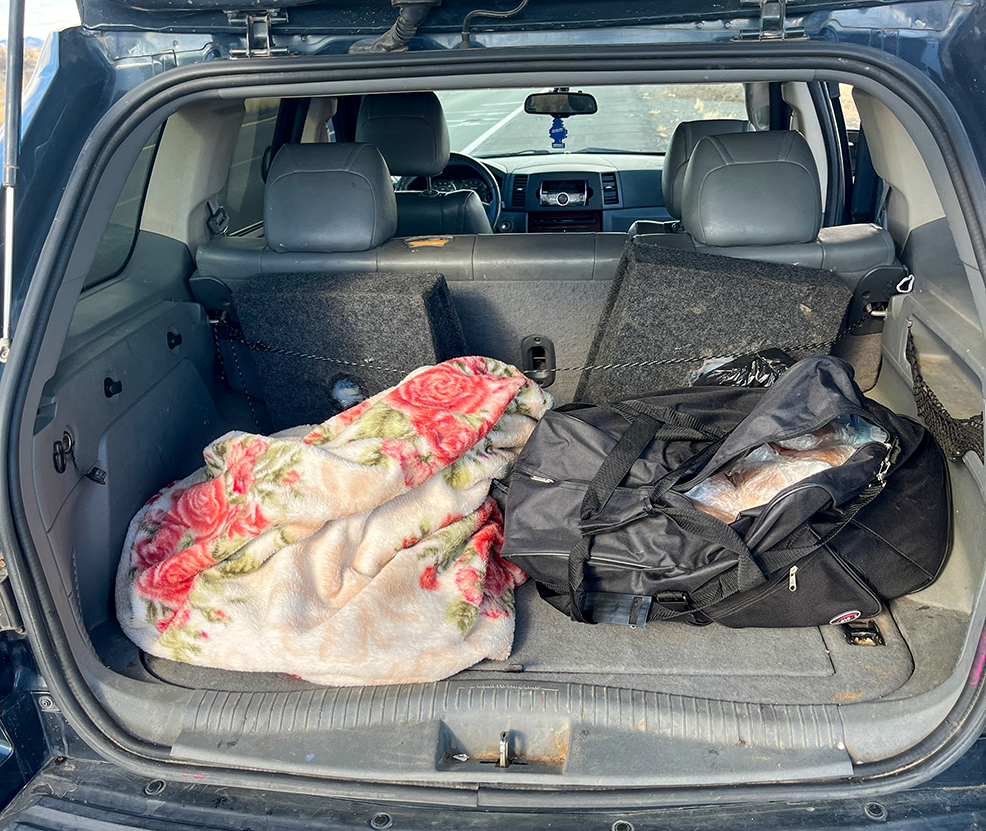 Bundles of drugs seen sticking out of a black bag in the back of a pickup truck