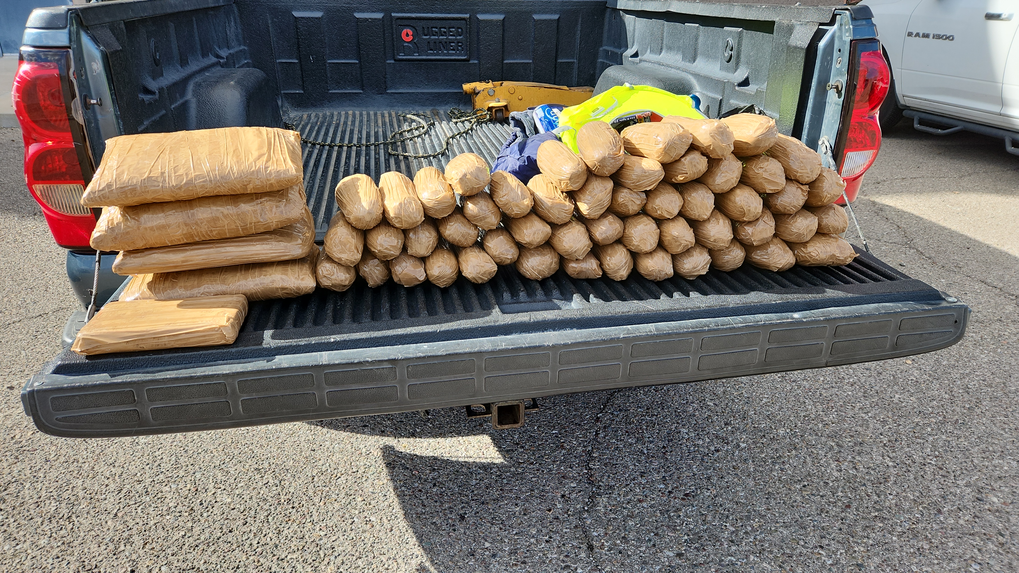Fentanyl and methamphetamine bundled in brown wrapping in the bed of a pickup truck