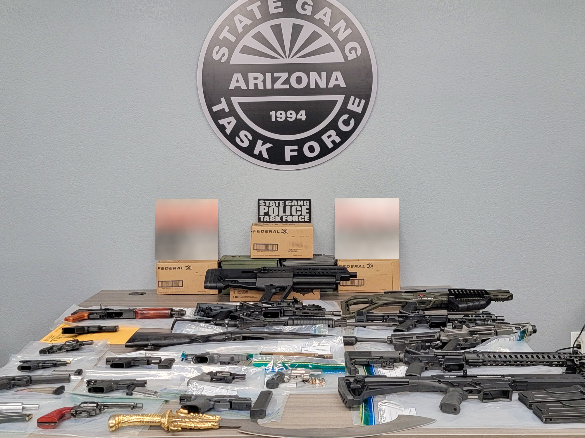 Guns, ammunition and other weapons displayed on a table 