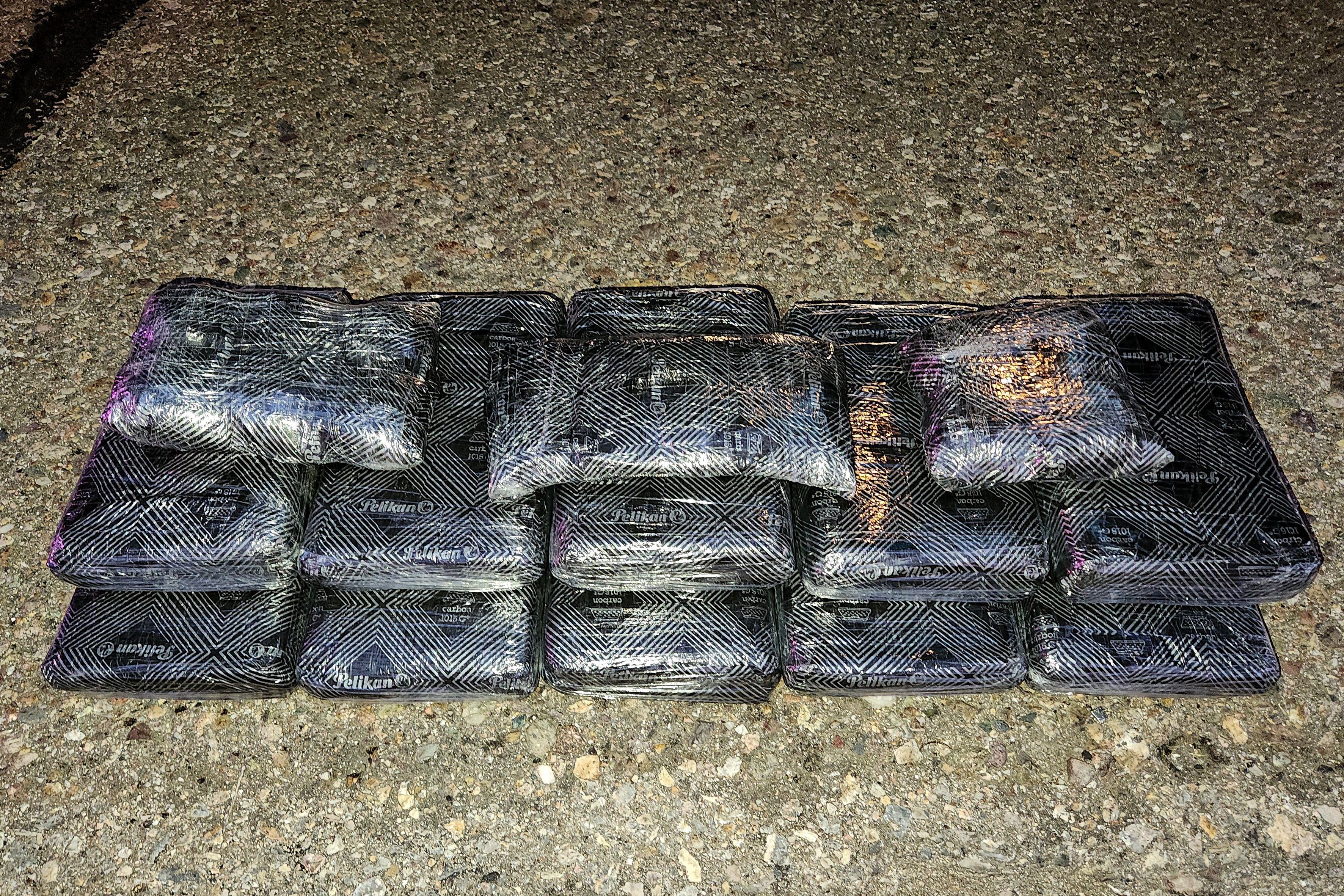Plastic wrapped black packages containing drugs