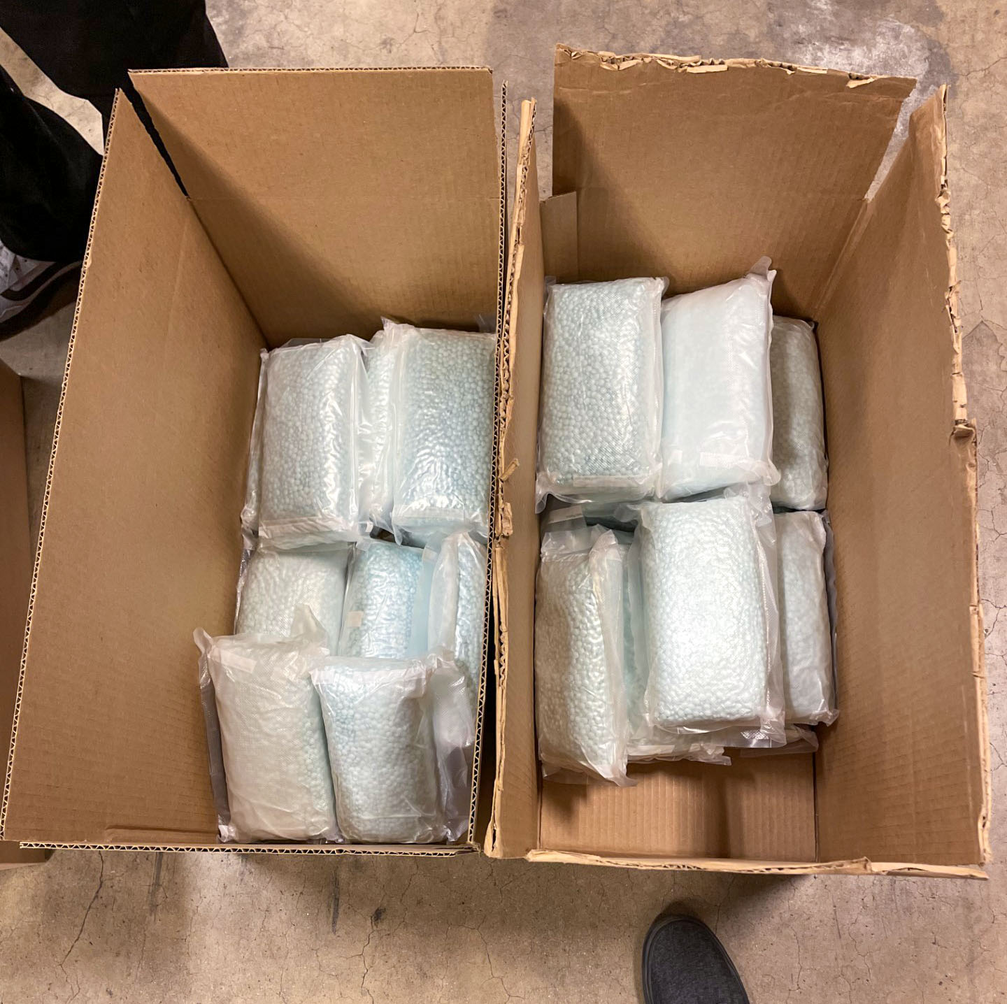 Bags of blue fentanyl-laced pills in cardboard boxes