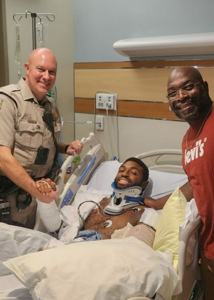 Trooper Hupp with Zaveion, the injured motorcyclist, and Zaveion's father