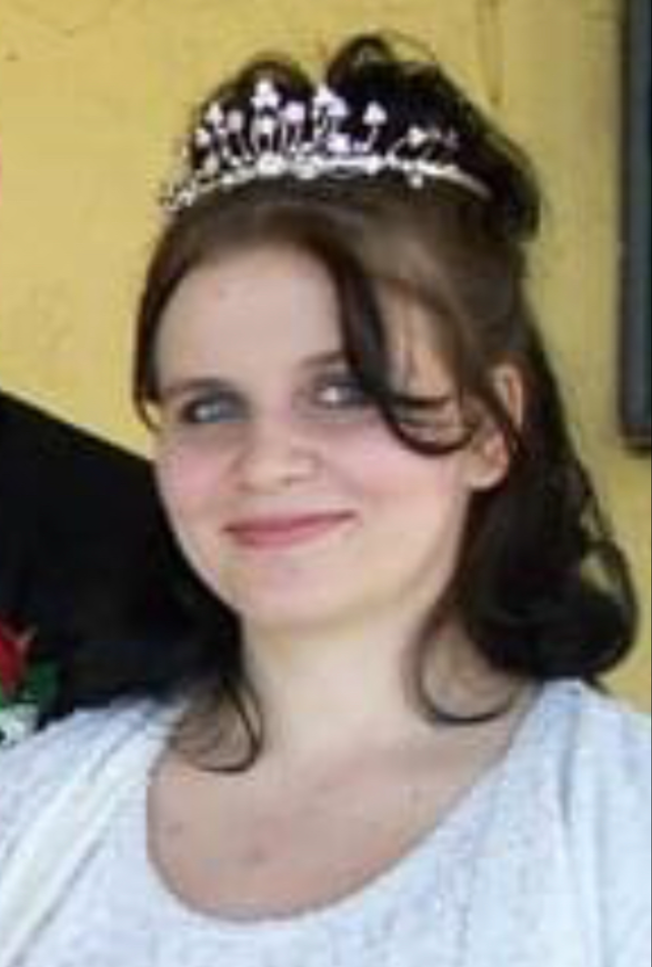 A photo of Jessica Eckersley smiling at the camera while wearing a tiara