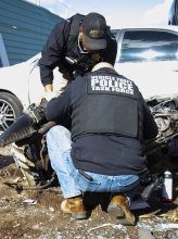 VTTF detectives look at cars and parts piled up in salvage yard