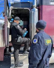 Inspectors talking with truck driver