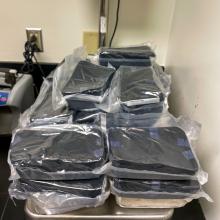 Several plastic wrapped packages of methamphetamine on a scale