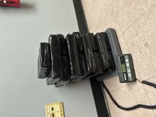 black tapped packages of drugs on scale