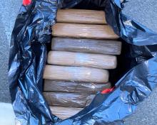 Cocaine bundles seized by AZDPS Canine District troopers shown in a black bag 