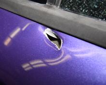 Photo of bullet hole in suspect vehicle
