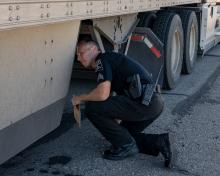 AZDPS Commercial Vehicle Enforcement trooper inspecting a CMV