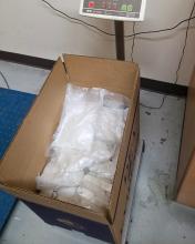 Packages of methamphetamine shown in a cardboard box