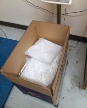 Packages of methamphetamine shown in a cardboard box