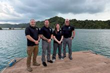 AZDPS personnel pose for a group photo on a dock in Palau.