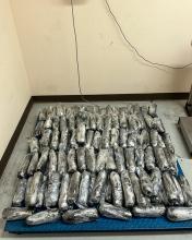 A photo of plastic-wrapped packages of methamphetamine laid out on a scale