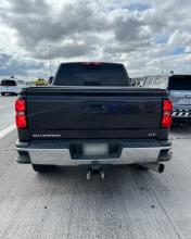 Back view of a gray Chevrolet pickup truck stopped on the shoulder of a highway with AZDPS vehicles around it.