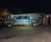 Blue pickup truck in front of a residence