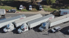 Tractor trailers and law enforcement vehicles are seen from above parked at an inspection area in northern Arizona