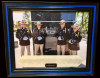Framed photo of troopers standing in front of a memorial