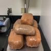 Several plastic wrapped packages of methamphetamine on a scale