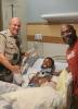 Trooper Hupp with Zaveion, the injured motorcyclist, and Zaveion's father