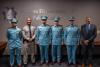 Colonel Glover and Brandon Battle of the IACP pose for a photo with Officer Alhefeiti, Officer Alshehhi, and Officer Alyammahi, as well as Captain Mohamed Alhmoudi during the promotion ceremony.  