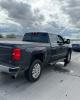 Side view of a gray Chevrolet pickup truck stopped on the shoulder of a highway with AZDPS vehicles around it.