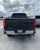 Back view of a gray Chevrolet pickup truck stopped on the shoulder of a highway with AZDPS vehicles around it.